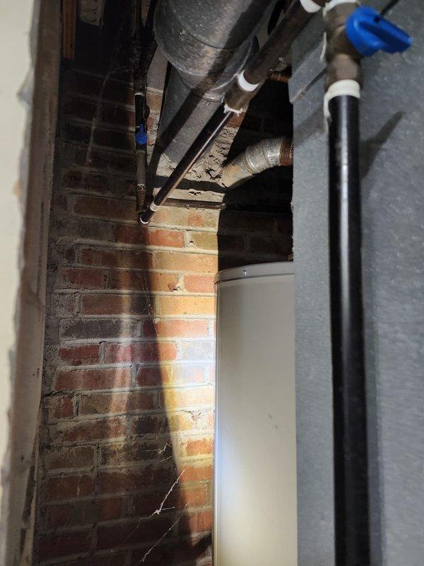 Completed furnace retrofit installation in utility closet with new high-efficiency unit and metallic ductwork connection. Installed chimney liner system through existing masonry structure to properly vent combustion gases, ensuring code compliance and safe operation. All HVAC components, including supply ductwork and venting infrastructure, were secured and tested for proper airflow and system functionality.