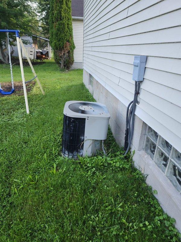 Completed installation of new residential air conditioning system including outdoor condensing unit and indoor evaporator coil. Positioned outdoor unit on concrete pad adjacent to home foundation with proper clearances, installed electrical disconnect box on exterior wall, and ran conduit for power supply. Inside basement utility area, installed new evaporator coil and integrated system with existing ductwork near water heater location. Verified all electrical connections to main panel, tested system operation, and confirmed proper refrigerant charge and airflow throughout. Unit operational and cooling effectively.