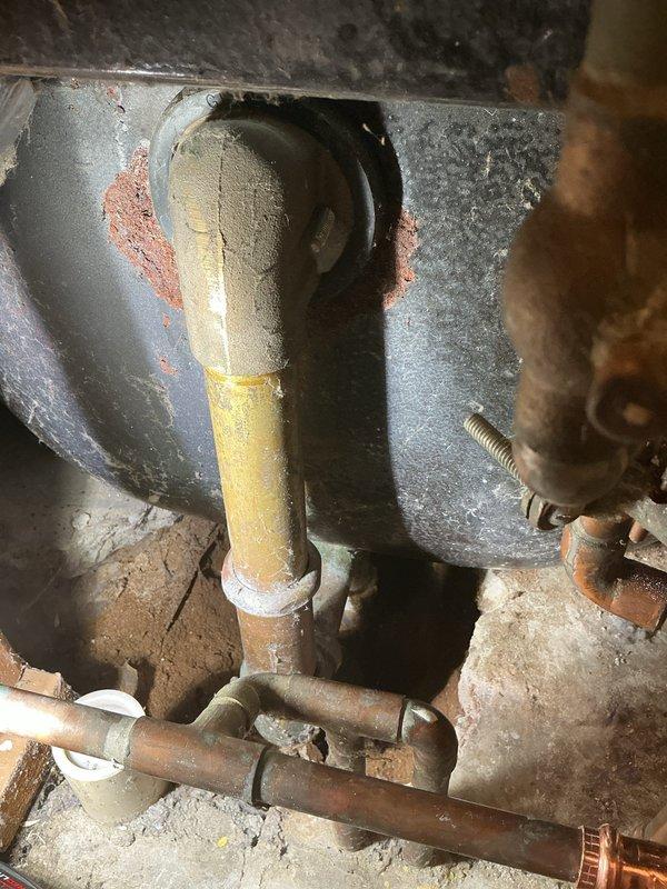 Responded to a shower leak located behind the washer and dryer access panel. Upon inspection, identified deteriorating plumbing connections with visible corrosion and rust staining on piping and surrounding metal panels. Accessed the affected area by moving appliances, repaired the leaking shower valve assembly, and addressed compromised pipe insulation showing significant wear and cracking. Tested the system to confirm proper operation and leak elimination.