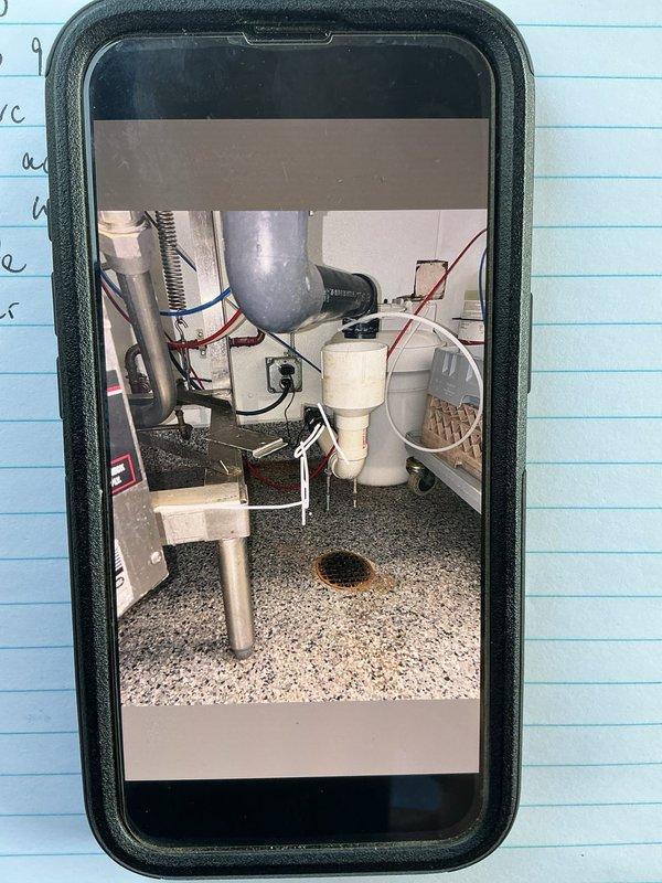Responded to service call for broken dishwasher drain line requiring rerouting. Performed on-site assessment of utility area to determine optimal drain path, documented existing plumbing configuration including PVC drainage system and mechanical installations, and compiled material list for main drain reroute as requested by property owner.