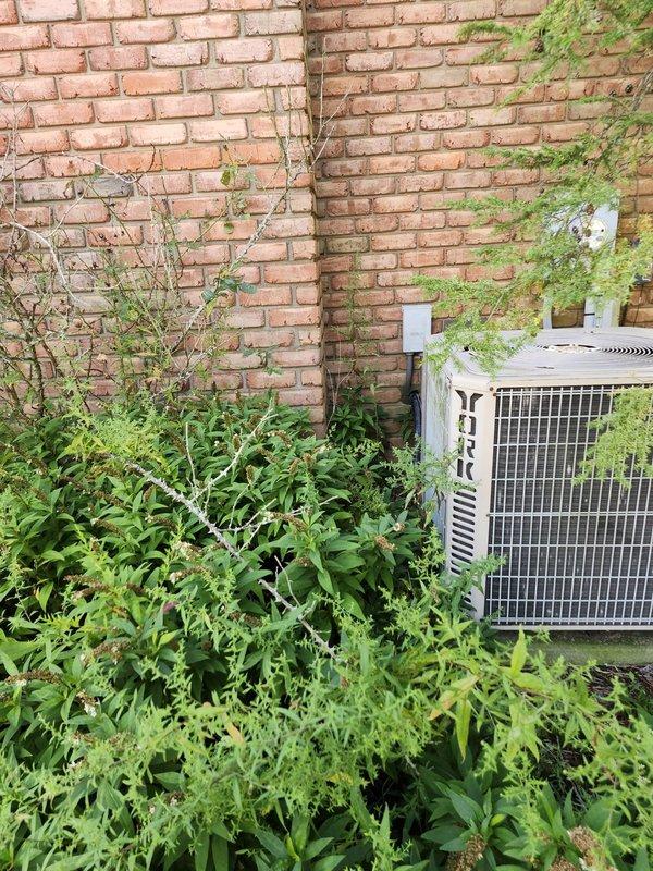 # HVAC Install - A/C & Coil

Completed full AC retrofit at residential property, replacing existing York condenser unit with new system. Removed old outdoor condensing unit from overgrown area against brick wall and relocated new equipment to improved position on brick paver pathway with proper clearances. Installed new evaporator coil inside air handler to match outdoor unit capacity and refrigerant type.

Ran new refrigerant line set with appropriate insulation from outdoor condenser to indoor coil connection point. Installed gray electrical disconnect box near outdoor unit per code requirements. Evacuated refrigerant lines to proper vacuum levels and charged system to manufacturer specifications. Verified proper refrigerant pressures on both high and low sides during system operation.

Commissioned new system with full operational testing including temperature split verification, amperage draw confirmation, and airflow assessment. Cleared vegetation and debris from installation area