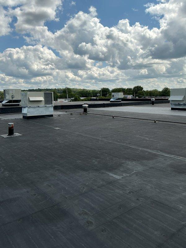 Completed preventive maintenance service on multiple commercial rooftop HVAC units installed on flat membrane roof. Performed comprehensive PM inspection procedures on all rooftop units, including operational checks, component inspection, and system evaluation. All equipment found to be in operational condition with units mounted on proper curb adapters and structural supports. Documentation completed with photographic records of installed equipment and rooftop conditions for service history.