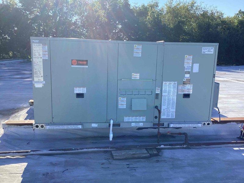 Responded to commercial property experiencing poor cooling conditions. Completed full rooftop unit replacement, installing new Trane commercial RTU system on existing roof curb assembly. Unit properly mounted on metal support frame with all electrical connections, refrigerant lines, and condensate drainage established through roof penetrations. System tested and operational, restoring full cooling capacity to facility.