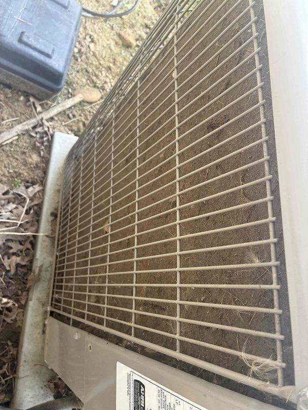 Responded to no cooling complaint in 5th and 6th grade classrooms while library was overcooling. Upon inspection, found RTU condenser unit with heavily soiled protective grille and condenser coil covered in dust, dirt, and debris accumulation, restricting airflow and reducing system efficiency. Cleaned condenser coil and grille, removed organic debris from unit vicinity, verified proper airflow restoration, and confirmed system operation returned to normal parameters with balanced cooling throughout affected zones.