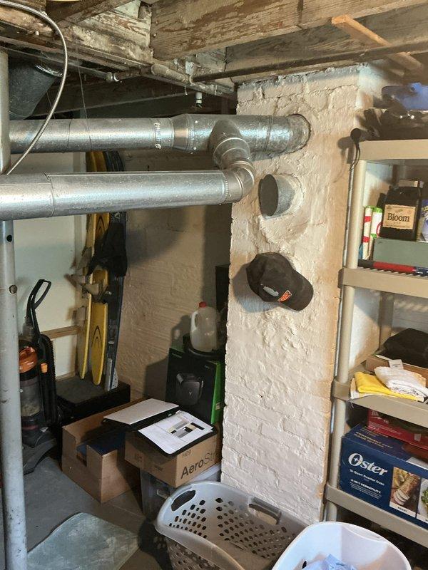 Conducted comprehensive assessment of existing basement furnace system and ductwork infrastructure to provide estimate for adding central air conditioning and potential complete HVAC system replacement. Evaluated current gray metal furnace unit with exposed blower motor and internal components, inspected existing galvanized ductwork distribution throughout basement ceiling, and assessed structural layout for optimal AC integration. Documented equipment specifications, measured available space for condenser placement, reviewed electrical capacity requirements, and analyzed ductwork modifications needed to accommodate cooling system installation.
