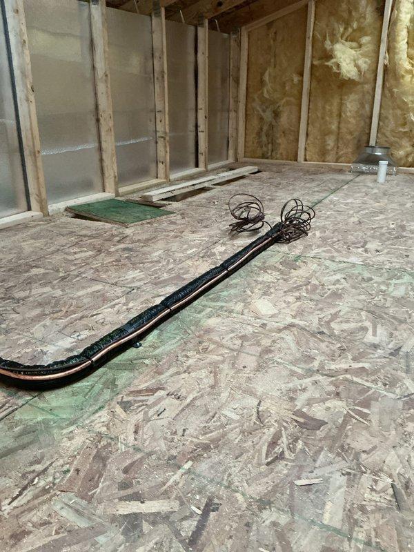Completed new construction HVAC installation at residential building site. Installed ductwork routing through floor joists and wall cavities in coordination with framing and insulation phases. System components positioned and secured per manufacturer specifications and building code requirements.