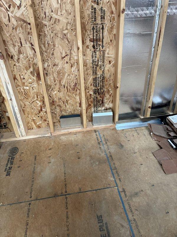 Completed rough-in installation for two HVAC systems and Reznor unit in new construction environment. All ductwork, registers, and mechanical components positioned according to specifications with materials list documented on-site. Installation coordinated with framing and insulation phases, ensuring proper clearances and structural integration for final system commissioning.