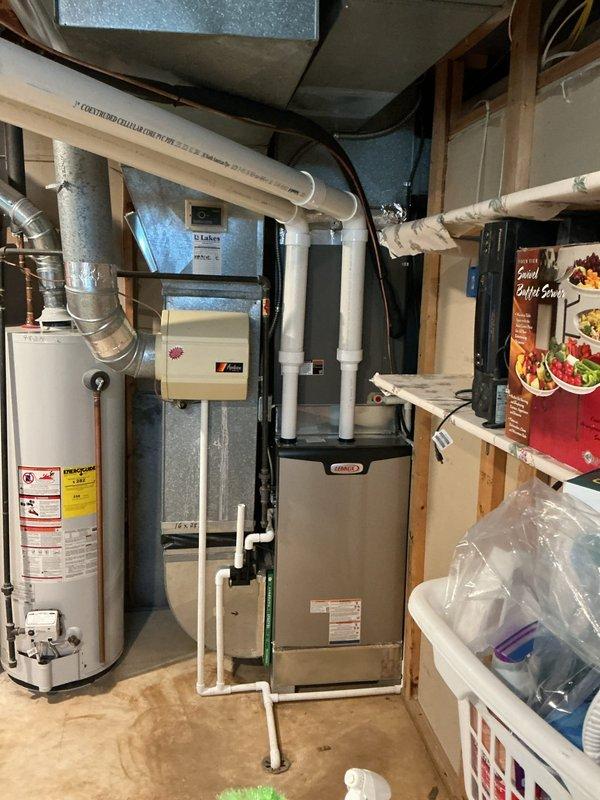 Completed furnace retrofit installation in basement mechanical room. Installed new Lennox furnace unit with proper PVC venting system routed vertically through ceiling joists. Connected unit to existing galvanized ductwork system and integrated air filtration component. Verified all exhaust and intake piping properly sealed and secured. System tested and operational.