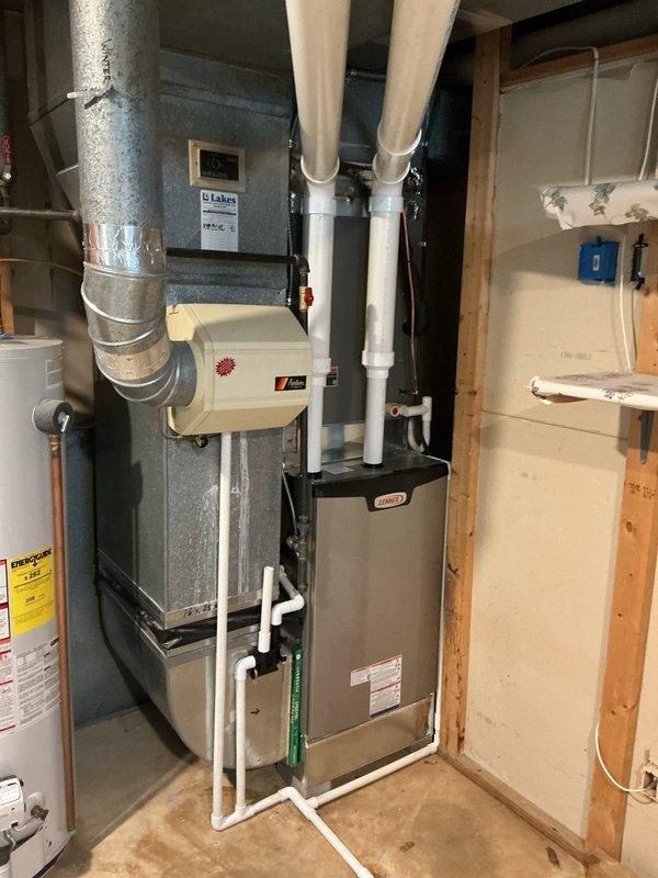 Completed furnace retrofit installation in basement mechanical room. Installed new Lennox furnace unit with proper PVC venting system routed vertically through ceiling joists. Connected unit to existing galvanized ductwork system and integrated air filtration component. Verified all exhaust and intake piping properly sealed and secured. System tested and operational.