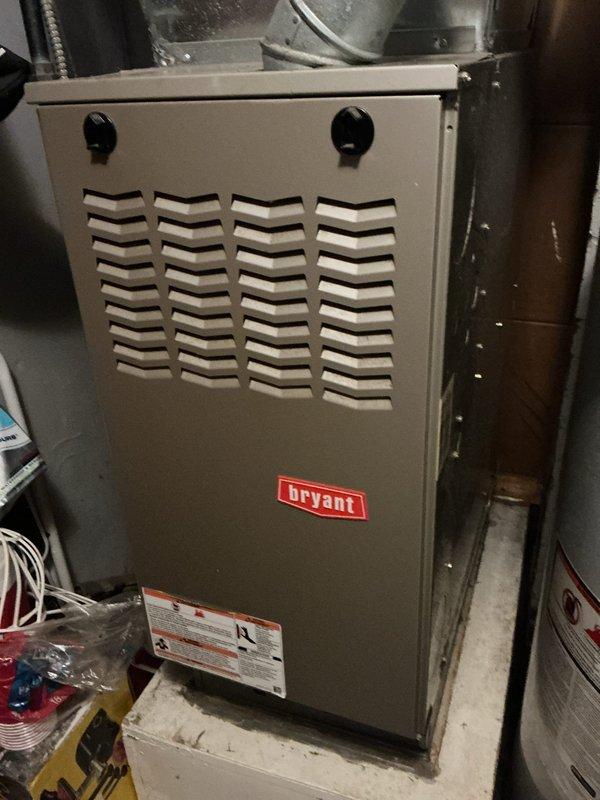 Completed HVAC estimate for air conditioning retrofit on rental property. Documented existing Bryant furnace installation in basement mechanical room, including current ductwork configuration, plenum connections, and refrigerant line routing. Assessed equipment accessibility, electrical service connections, and available space for proposed AC system integration with existing forced-air heating system.