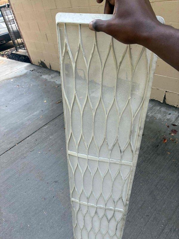 Responded to callback for non-operational lab unit. Upon arrival, found heavily soiled air filter restricting airflow and system unable to maintain proper operation. Removed and documented dirty filter condition. Connected Fieldpiece manifold gauges to service ports to verify refrigerant pressures and system performance. Cleaned debris accumulation from outdoor unit platform area. Installed new filter, verified proper airflow restoration, and confirmed unit returned to normal operation with acceptable operating pressures.