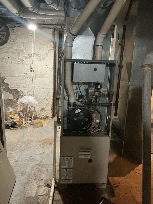 Completed furnace and air conditioning retrofit at residential property. Removed existing HVAC equipment from basement mechanical room and installed new gas furnace with updated ductwork connections. Configured blower motor assembly and verified proper electrical connections throughout the system. Tested all components for proper operation and airflow distribution through existing duct network.