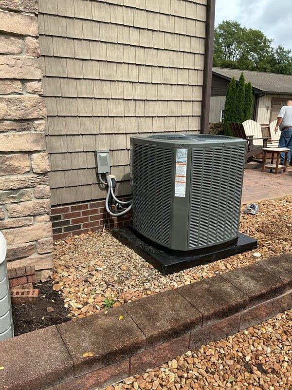 Completed air conditioning system retrofit and preventive maintenance service. Installed new outdoor condensing unit on concrete pad with proper refrigerant line routing and electrical connections through exterior wall. Verified system operation and documented installation with interior mechanical space and exterior unit placement photographs showing proper clearances and professional installation standards.