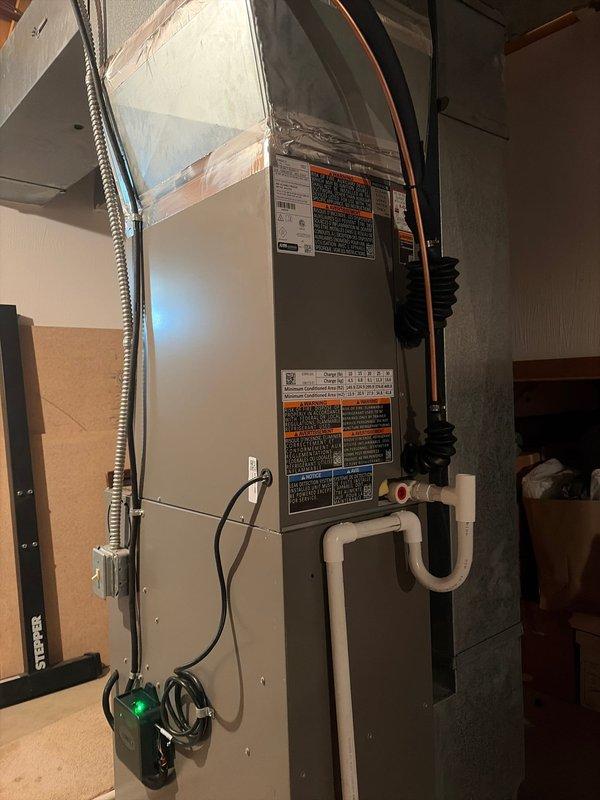 Completed full air conditioning retrofit installation including new Lennox outdoor condensing unit and indoor air handler with evaporator coil. Installed air handler in attic space with proper refrigerant line set, electrical connections via flexible conduit, and PVC condensate drain with trap. Positioned outdoor unit on gravel pad against building exterior with proper clearances, connected electrical disconnect, and completed all refrigerant piping connections. System tested and verified operational with all safety controls functioning properly.
