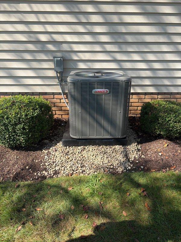 Completed full air conditioning retrofit installation including new Lennox outdoor condensing unit and indoor air handler with evaporator coil. Installed air handler in attic space with proper refrigerant line set, electrical connections via flexible conduit, and PVC condensate drain with trap. Positioned outdoor unit on gravel pad against building exterior with proper clearances, connected electrical disconnect, and completed all refrigerant piping connections. System tested and verified operational with all safety controls functioning properly.