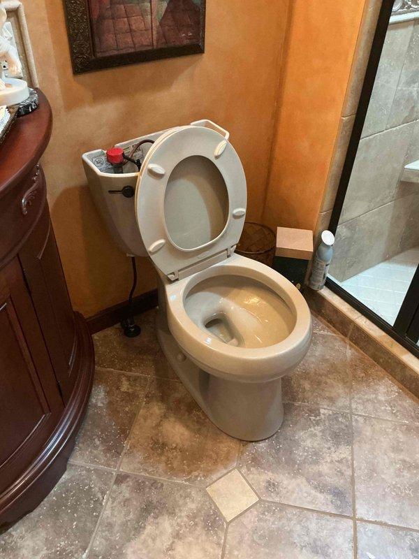 Responded to reported leak at residential property where water supply had been shut off by homeowner. Upon arrival, inspected toilet fixture and identified source of leak requiring replacement. Removed existing toilet from floor flange, inspected wax ring and flange condition, and confirmed proper drain alignment. Installed new toilet unit, securing it to floor with appropriate hardware and ensuring level placement on travertine tile flooring. Applied new wax ring seal to establish watertight connection between toilet base and drain flange. Reconnected water supply line to fill valve, restored water service, and performed multiple flush cycles to verify proper operation and confirm elimination of leak. Inspected all connections for seepage and verified stable water level in bowl and tank with no active leaks present upon completion.