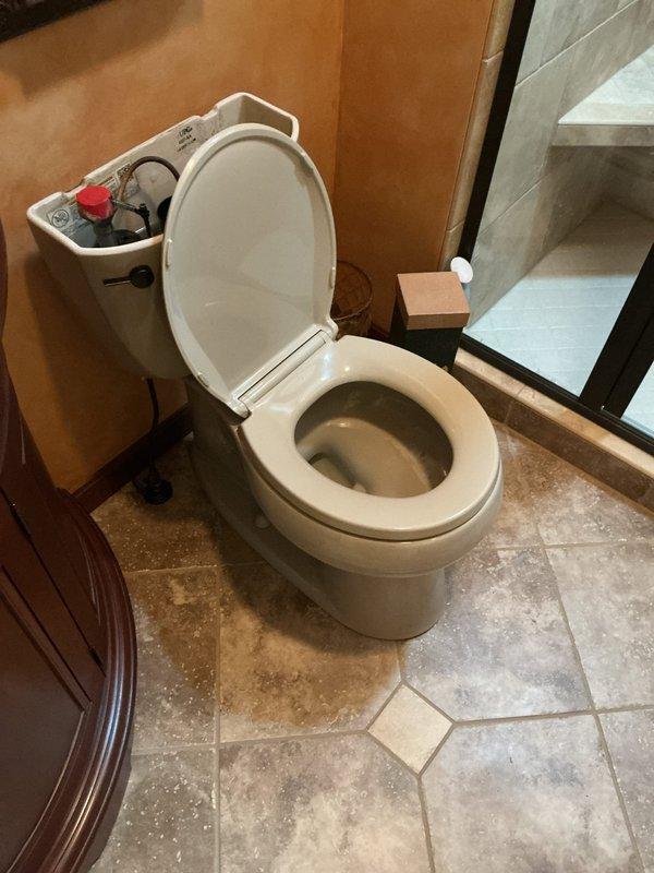 Responded to reported leak at residential property where water supply had been shut off by homeowner. Upon arrival, inspected toilet fixture and identified source of leak requiring replacement. Removed existing toilet from floor flange, inspected wax ring and flange condition, and confirmed proper drain alignment. Installed new toilet unit, securing it to floor with appropriate hardware and ensuring level placement on travertine tile flooring. Applied new wax ring seal to establish watertight connection between toilet base and drain flange. Reconnected water supply line to fill valve, restored water service, and performed multiple flush cycles to verify proper operation and confirm elimination of leak. Inspected all connections for seepage and verified stable water level in bowl and tank with no active leaks present upon completion.