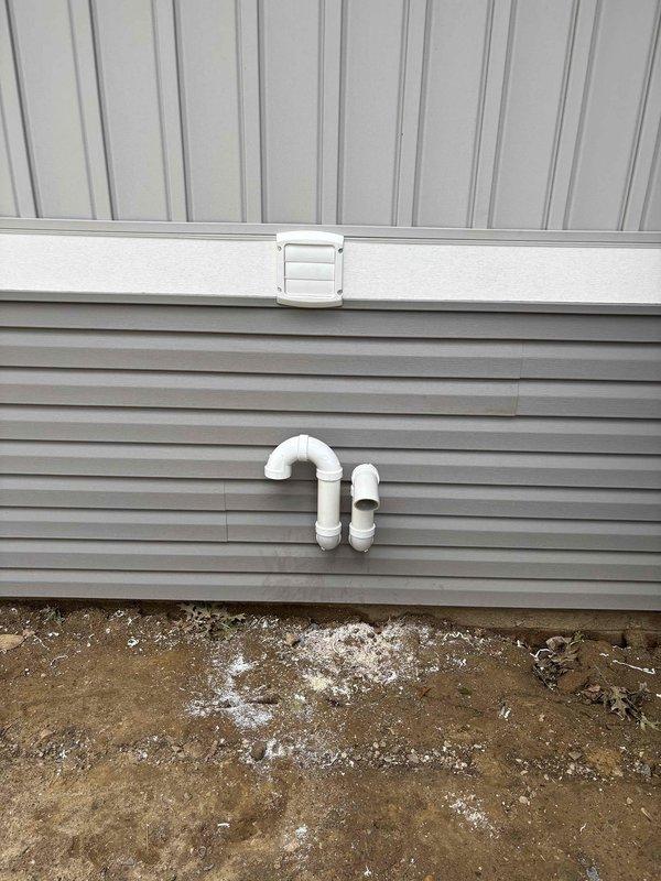 Completed new construction HVAC installation including furnace and ductwork system in crawl space. Installed main trunk line with galvanized metal ductwork properly supported from floor joists, along with flexible branch connections for distribution throughout the structure. Applied vapor barrier ground cover for moisture control and installed reflective insulation on foundation walls per code requirements. Exterior work included installation of PVC condensate drain system with proper trap configuration mounted to building exterior, ensuring adequate drainage away from foundation. All ductwork sealed and secured, system ready for startup and commissioning.