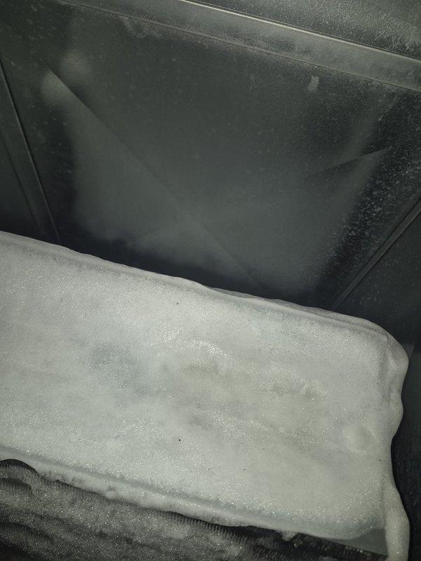 Responded to service call for A/C unit not turning on with water accumulation near equipment. Upon inspection, discovered severe frost and ice buildup on evaporator coil with significant condensation on interior components. Diagnosed restricted airflow causing coil to freeze, which resulted in water leakage when ice melted. Inspected indoor air handler unit and verified refrigerant lines, condensate drain system, and all mechanical connections. Addressed frozen coil condition, cleared condensate drainage issue, and restored proper system operation. Unit tested and confirmed cooling cycle functioning normally with no further water leakage.