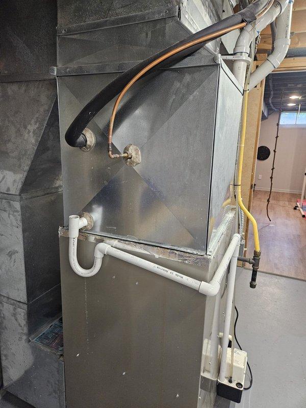 Responded to service call for A/C unit not turning on with water accumulation near equipment. Upon inspection, discovered severe frost and ice buildup on evaporator coil with significant condensation on interior components. Diagnosed restricted airflow causing coil to freeze, which resulted in water leakage when ice melted. Inspected indoor air handler unit and verified refrigerant lines, condensate drain system, and all mechanical connections. Addressed frozen coil condition, cleared condensate drainage issue, and restored proper system operation. Unit tested and confirmed cooling cycle functioning normally with no further water leakage.