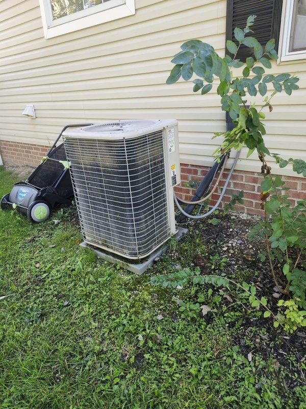 Completed full HVAC system retrofit including furnace and air conditioning equipment. Installed new outdoor condensing unit on existing concrete pad with proper refrigerant line connections and electrical conduit routed through exterior wall. Verified all connections secure and system operational. Equipment positioned against structure with adequate clearance for airflow and future service access.
