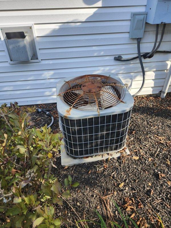 Completed A/C retrofit installation including new outdoor condensing unit and indoor evaporator coil matched to existing Carrier furnace system. Removed and properly disposed of old weathered outdoor unit that showed significant rust and corrosion on housing and base components. Installed new condensing unit on existing concrete pad, established refrigerant line connections using copper piping, and ran new electrical disconnect with conduit to exterior wall mount. Indoor evaporator coil was installed above furnace in existing ductwork plenum with proper refrigerant line routing through utility space. Verified all electrical connections at disconnect box, completed refrigerant charging to manufacturer specifications, and tested system operation for proper cooling cycle. System achieved target temperatures with appropriate airflow through ductwork. All connections secured and leak-tested per industry standards.