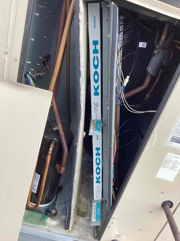Performed scheduled commercial heating maintenance on rooftop packaged HVAC unit. Conducted comprehensive inspection of refrigerant lines, electrical connections, and evaporator coil assembly, documenting equipment condition with interior and exterior photography. Unit operational with minor dust accumulation noted in air handler compartment.