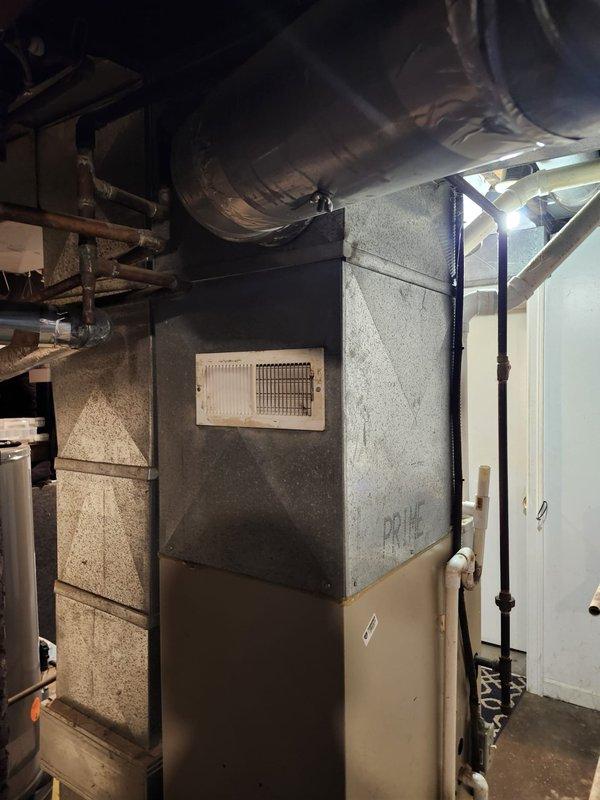 Completed full HVAC system installation in basement utility area, including new furnace unit with integrated ductwork and ventilation components. Installed and connected white PVC condensate drainage piping and copper refrigerant lines with proper fittings and support. Configured metallic supply ductwork to ceiling joists with appropriate hangers and sealed all connections to ensure efficient airflow distribution throughout the residence.