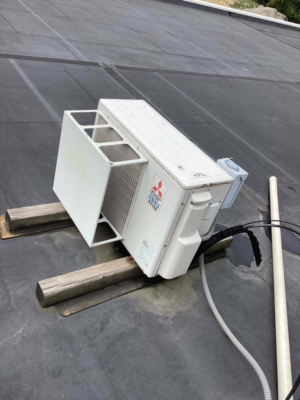 Responded to service call for Mitsubishi mini-split system displaying AE error code. Inspected both outdoor condenser unit located on flat roof and indoor air handler mounted in interior space. Diagnosed error code, performed necessary troubleshooting and system diagnostics, and resolved the fault condition. Verified proper operation of both indoor and outdoor units upon completion, with system returning to normal functionality.