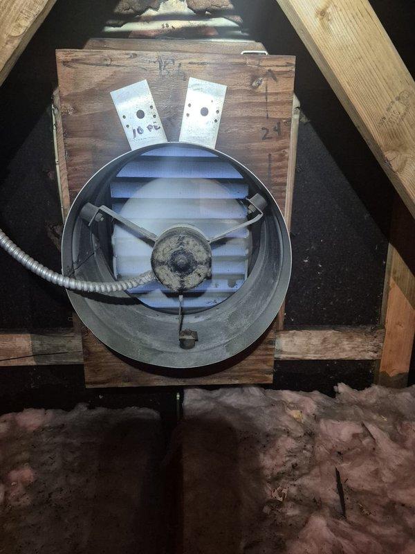 Completed installation of attic exhaust ventilation system including mounting of circular exhaust fan units within wooden framework between roof joists. Established proper electrical connections with junction boxes, verified motor operation, and ensured adequate airflow capacity for attic space ventilation in accordance with new construction specifications.