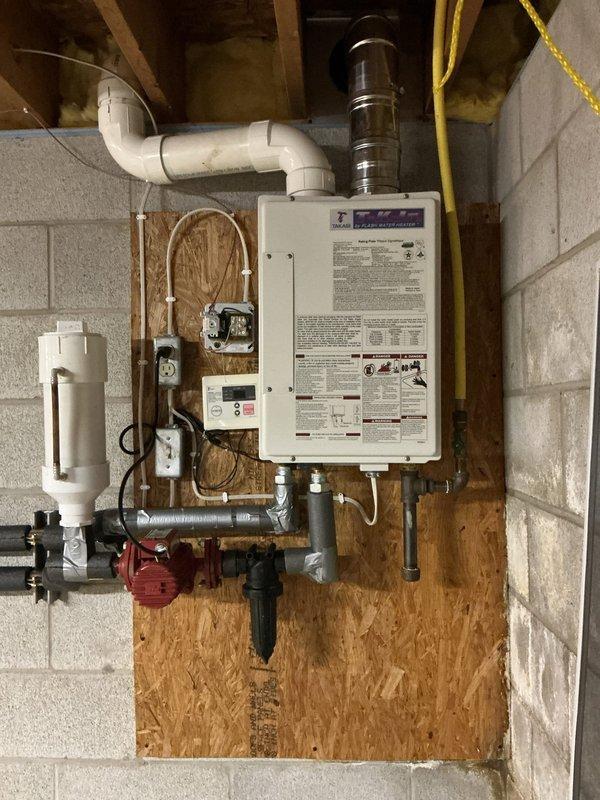 Performed comprehensive descaling maintenance on wall-mounted tankless water heater system. Flushed unit using descaling solution to remove mineral buildup from heat exchanger, ensuring optimal performance and efficiency. Verified all plumbing connections, gas lines, and venting system were secure and functioning properly upon completion.