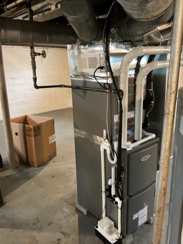 Completed full HVAC system retrofit in basement mechanical room, installing new Lennox furnace with integrated air handler and condensate pump assembly. Connected all supply and return ductwork, installed PVC venting and drainage piping, verified proper airflow distribution, and tested system operation to ensure optimal heating and cooling performance.