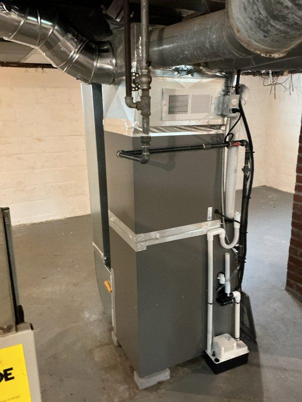Completed full HVAC system retrofit in basement mechanical room, installing new Lennox furnace with integrated air handler and condensate pump assembly. Connected all supply and return ductwork, installed PVC venting and drainage piping, verified proper airflow distribution, and tested system operation to ensure optimal heating and cooling performance.
