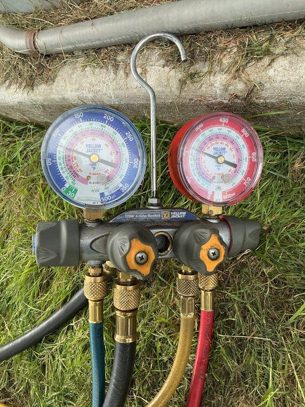 Replaced failed compressor on commercial walk-in cooler unit. System was evacuated using digital vacuum gauge to achieve proper 500-micron vacuum level, then recharged with appropriate refrigerant using manifold gauge set to verify correct operating pressures across both high and low sides.