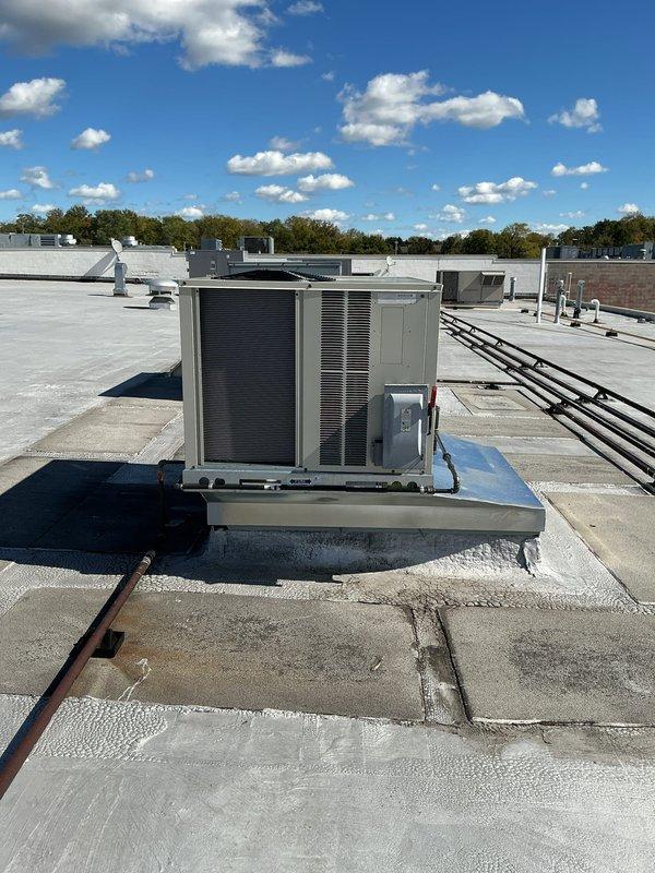 Successfully installed a 4-ton Daikin rooftop package unit on commercial building. Unit was mounted on elevated curb adapter with proper platform support, electrical conduit and refrigerant lines connected per manufacturer specifications, and all technical components secured for optimal operation.