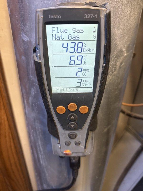 Completed fall maintenance tune-up on 15-20 year old gas furnace located in basement as part of annual preventative maintenance package. Performed comprehensive inspection of all system components including burner assembly, heat exchanger, gas valves, ignition system, and blower motor. Conducted combustion analysis using Testo 327-1 analyzer, which confirmed safe operating parameters with oxygen levels at 6.9%, carbon monoxide at 2 ppm, and carbon monoxide air-free at 3 ppm. Verified proper gas combustion efficiency and flue gas temperatures within manufacturer specifications. Inspected burner flames for proper ignition and uniform flame pattern across all burners. Checked all electrical connections, control wiring, and safety switches for secure operation. Examined PVC venting system for proper drainage and clearances. Tested thermostat operation and system cycling. All components found to be functioning properly with no immediate repairs needed at this time. System is operating safel