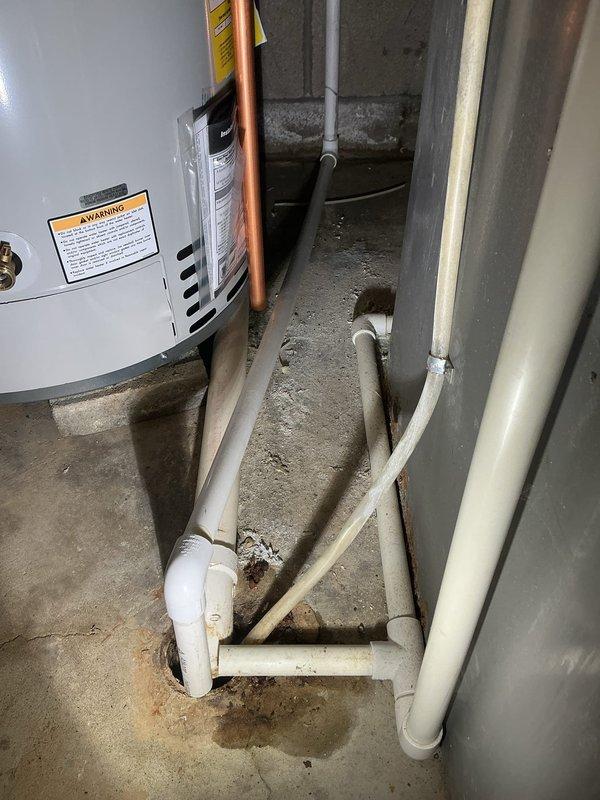Completed installation of a 50-gallon Bradford White gas water heater in basement utility area. Installed unit on concrete floor with proper connections including copper supply lines, gas line, and venting through existing ductwork. Configured all plumbing connections with appropriate fittings and ensured proper drainage lines were in place. Verified all safety labels and warning tags were visible and unit was secured according to manufacturer specifications and local code requirements.