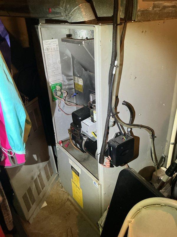 Completed furnace retrofit installation in residential basement mechanical room. Replaced existing heating unit with new furnace system, including integration of blower motor assembly, heat exchanger, and electronic control board with updated wiring connections. Installed new copper refrigerant lines and verified proper connection to existing ductwork system. All electrical connections completed to code with appropriate disconnect switch and safety labeling applied to unit exterior and interior compartments.
