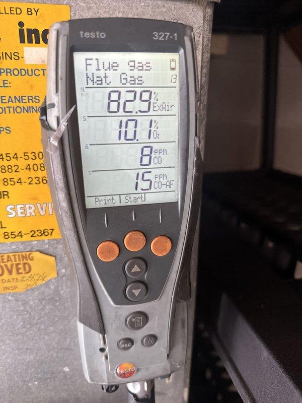 Performed comprehensive heating maintenance on gas furnace system. Removed access panel and inspected internal components including gas valve assembly, draft inducer motor, and burner assembly. Cleaned all accessible components, removing dust and debris accumulation from motor housing and interior surfaces. Conducted combustion analysis using Testo 327-1 analyzer, recording oxygen levels at 10.1%, efficiency at 82.9%, and carbon monoxide readings at 15 PPM ambient with 0 PPM in flue gas, confirming safe and efficient operation. Verified all electrical connections to gas valve and inducer motor were secure. Reinstalled access panel and secured unit upon completion. System operating within normal parameters.