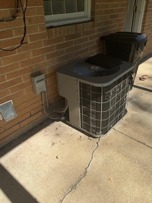 Completed full HVAC system replacement including furnace and air conditioning condenser unit. Installed new outdoor AC unit on existing concrete pad with proper electrical disconnect and refrigerant line connections to brick exterior. Replaced indoor furnace system with associated PVC venting and condensate drainage piping secured to ceiling structure with appropriate mounting hardware.