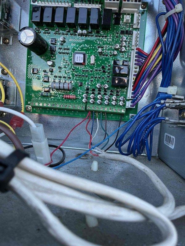 Completed fall maintenance on commercial HVAC unit. Performed comprehensive inspection of control board, electrical connections, and blower motor assembly. Verified all wire terminations at circuit board and junction box are secure. Inspected main control PCB with microprocessor, relays, and associated components for proper operation. Checked blower motor housing and internal components, noting minor surface rust on base panel. Confirmed all safety labels and warnings are present and legible. Documented equipment condition with photographs of control system and blower assembly. System operational upon completion of preventive maintenance procedures.
