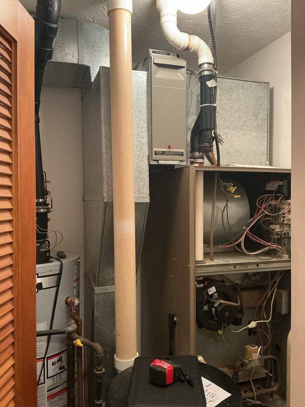 Completed furnace retrofit in residential mechanical closet. Removed existing heating equipment and installed new furnace unit with proper clearances alongside existing water heater and tankless water heater. Configured refrigerant lines, electrical connections, and ductwork integration to accommodate the compact utility space layout.