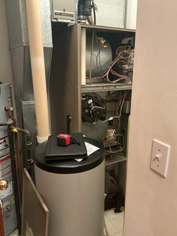 Completed furnace retrofit in residential mechanical closet. Removed existing heating equipment and installed new furnace unit with proper clearances alongside existing water heater and tankless water heater. Configured refrigerant lines, electrical connections, and ductwork integration to accommodate the compact utility space layout.