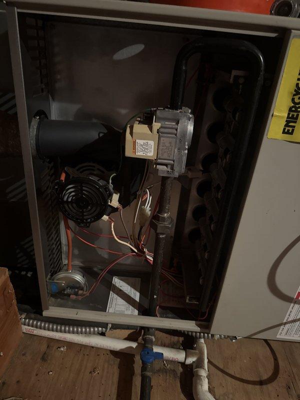 # Furnace Maintenance Completed

Performed comprehensive preventive maintenance on a 30-year-old gas furnace system. Accessed internal components by removing front service panel to inspect blower motor assembly, inducer motor, and electrical connections. Verified proper operation of all mechanical components including blower wheel and motor mountings. Inspected wiring throughout unit, noting red, white, and black conductor connections to control board and safety devices. 

Examined air filtration system, noting significant dust accumulation on mesh filter screen. Cleaned or replaced filter media as needed to restore proper airflow. Checked filter retention mechanism and housing integrity. Inspected copper refrigerant or gas lines at unit base, including connections and shut-off valve. Verified flexible conduit connections remained secure.

Tested all electrical connections and control circuits for proper voltage and continuity. Confirmed blower motor operation and assessed overall syst