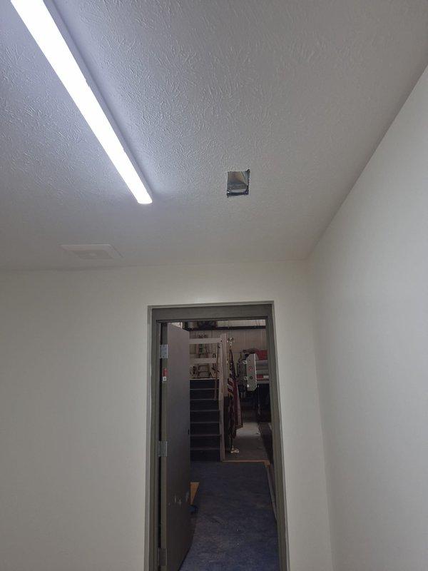 Conducted a new construction site walkthrough of the commercial space to assess HVAC requirements and compile a register list. Documented existing ceiling conditions, including rough-in cutouts and an installed ceiling grille, and photographed the locations to verify register placement and sizing for the supply and return air distribution.