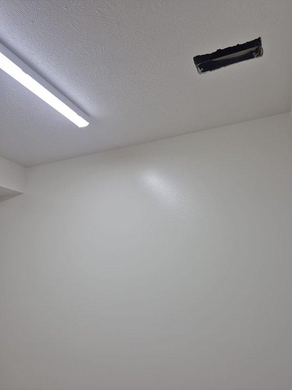 Conducted a new construction site walkthrough of the commercial space to assess HVAC requirements and compile a register list. Documented existing ceiling conditions, including rough-in cutouts and an installed ceiling grille, and photographed the locations to verify register placement and sizing for the supply and return air distribution.