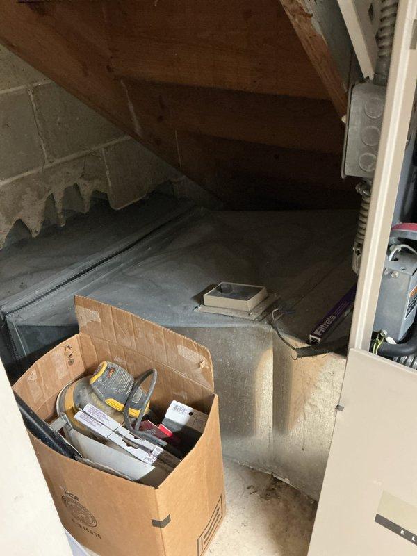 Performed an on-site evaluation for a full system replacement, inspecting the exterior condenser and the indoor air handler/plenum assembly. The condenser coil exhibited heavy debris and dirt accumulation, with vegetation encroaching on required clearances, and the indoor unit, ductwork, electrical connections, and filter area were documented for sizing and compatibility. Findings were recorded to support a complete system replacement recommendation.