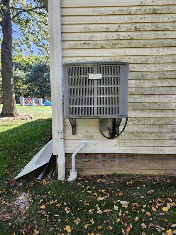 Completed a full HVAC system installation, including a new Lennox outdoor condenser unit set on a composite pad with properly routed refrigerant line set, electrical disconnect, and flexible conduit connections. The system supplies a full-capacity unit serving the garage and a half-capacity unit serving the house, with condensate drainage terminated to a PVC drain stub away from the foundation. Unit was left clean and secure with no visible damage.