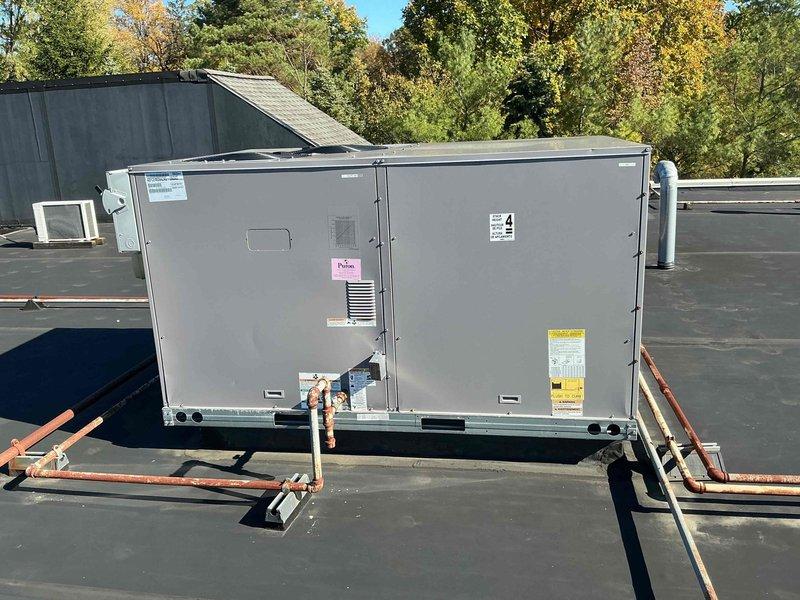 Performed scheduled preventive maintenance on a commercial rooftop package unit, inspecting the cabinet, refrigerant/gas piping, and exterior panels. Installed a new set of four pleated filters in the air handler section and verified proper seating in the filter tracks, with the blower motor assembly and wiring inspected and found in serviceable condition. Noted corrosion on the exterior rooftop piping and recommend monitoring or treatment to prevent further deterioration.