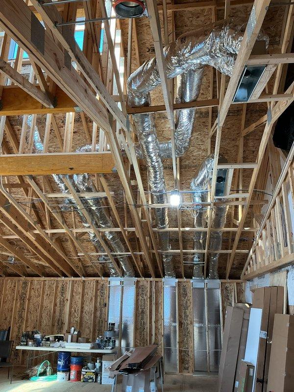 Replaced flexible ductwork with rigid hard pipe on all return air runs in the framed ceiling and wall cavities to improve airflow performance and system durability. Secured and sealed all transitions and connections to boots and collars to ensure proper return air delivery under the new construction warranty.